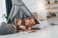 Learning to draw. Girls is laying down in the tent. Group of children is together at home at daytime Royalty Free Stock Photo