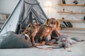 Learning to draw. Girls is laying down in the tent. Group of children is together at home at daytime Royalty Free Stock Photo