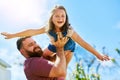Learning to fly because thats what angels do. an adorable little girl having fun with her father in their backyard. Royalty Free Stock Photo