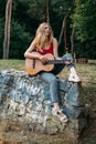 Learning to play the guitar. Beginner Guitar Lesson. Close-up of female hand playing Acoustic guitar. Music education and extra- Royalty Free Stock Photo