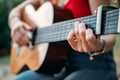 Learning to play the guitar. Beginner Guitar Lesson. Close-up of female hand playing Acoustic guitar. Music education and extra- Royalty Free Stock Photo