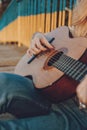 Learning to play the guitar. Beginner Guitar Lesson. Close-up of female hand playing Acoustic guitar. Music education and extra- Royalty Free Stock Photo