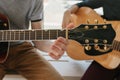 Learning to play the guitar. Music education and extracurricular lessons. Hobbies and enthusiasm for playing guitar and Royalty Free Stock Photo