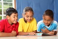 Learning together three happy young school kids