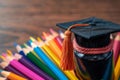 Learning triumph Graduation hat surrounded by vibrant colored pencils