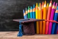 Learning triumph Graduation hat surrounded by vibrant colored pencils