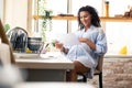 Happy expectant mother reading her pregnancy calendar.