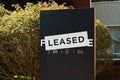 For lease and leased sign on a black display outside of a resedential building Royalty Free Stock Photo