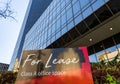 For Lease sign in front of mirrored surface of a modern skyscraper in St Louis Royalty Free Stock Photo