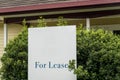 For lease sign on a white display outside of a house in Australia. Investment property real estate concept Royalty Free Stock Photo