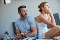 At least talk to me...a concerned mature man trying to talk to his moody wife after a disagreement in their bedroom. Royalty Free Stock Photo