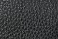 Leather background, black, shiny, bumpy, textured. Bonded reconstituted leather. Dark backdrop or wallpaper. Substitute for Royalty Free Stock Photo