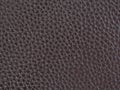 Leather background, brown, bumpy, textured. Bonded reconstituted leather. Substitute for genuine natural material. Dark backdrop