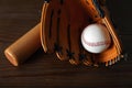 Leather baseball ball, bat and glove on table Royalty Free Stock Photo