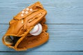 Leather baseball glove with ball on grey wooden table, top view. Space for text Royalty Free Stock Photo