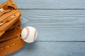 Leather baseball glove with ball on grey wooden table, top view. Space for text Royalty Free Stock Photo