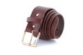 leather belt brown with gold buckle rolled up on a white background with shadow