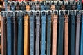 Leather belts in various colors displayed in a store Royalty Free Stock Photo