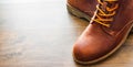 Leather boots shoes on the brown wooden table background.with copy space. Royalty Free Stock Photo