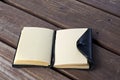 Leather bound black journal outdoors on table with blank pages