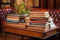 leather-bound books piled on a mahogany table