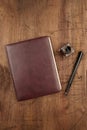 A leather bound journal, and ink well and pen Royalty Free Stock Photo