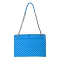 Leather bright blue female bag with silver large chain Royalty Free Stock Photo