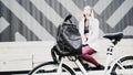 Leather brown bag in focus. young woman with backpack and vintage bike in city parking. Nature color toning for Royalty Free Stock Photo