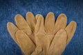 Leather brown construction gloves on scratched metallic surface Royalty Free Stock Photo