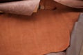 Leather brown pieces and rolls.Leatherworking. Genuine leather piece of brown colors.Manufacturing of clothes, shoes and Royalty Free Stock Photo