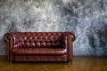 Leather brown sofa in urban loft interior