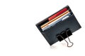 Leather cardholder with credit cards on a white background. Cardholder clamped by a paper clip. The symbol of the electronic
