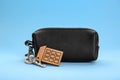 Leather case with keys on light blue background Royalty Free Stock Photo