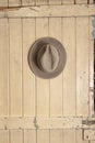 Leather cowboy hat hanging on an old door Royalty Free Stock Photo