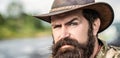 Leather Cowboy Hat. Portrait of young man wearing cowboy hat. Cowboys in hat. Handsome bearded macho. Man unshaven Royalty Free Stock Photo