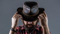 Leather Cowboy Hat. Portrait of young man wearing cowboy hat. Cowboys in hat. Handsome bearded macho. Man unshaven Royalty Free Stock Photo