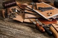 Leather craft tools on old wood table. Leather craft workshop