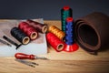Leather crafting tools. Set of leather craftman tools with colorful threads Royalty Free Stock Photo