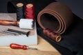 Leather crafting tools. Set of leather craftman tools with colorful threads Royalty Free Stock Photo