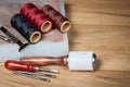 Leather crafting tools. Set of leather craftman tools with colorful threads Royalty Free Stock Photo
