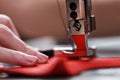 A leather craftsman produces leather goods on a sewing machine in his shop