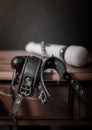Leather cuffs and a magic wand on a wooden table Royalty Free Stock Photo