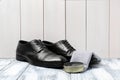 Leather footwear and shoe shine kit on white wooden Royalty Free Stock Photo