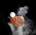 Leather glove mitt receive hit baseball ball and dust soil explode in air. Baseball ball throw and hit to center of mitt glove. Royalty Free Stock Photo