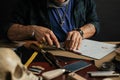 Leather goods master and handmade leather wallets. Workflow in the workshop.