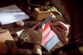 Leather handbag craftsman at work in a vintage workshop. Small business concept