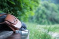 Leather handbag, smartphone and jacket on a park bench, nobody