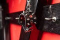 Leather handcuffs with studs on wooden cross