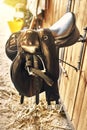 Leather horse saddle in a stable hanging on the wall Royalty Free Stock Photo