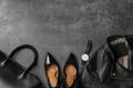 Leather jacket, shoes, bag and wristwatch on stone table, flat lay. Space for text